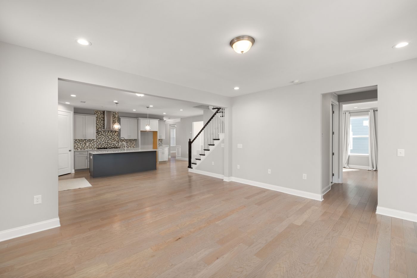 Bright, modern open-concept space with new light vinyl plank flooring