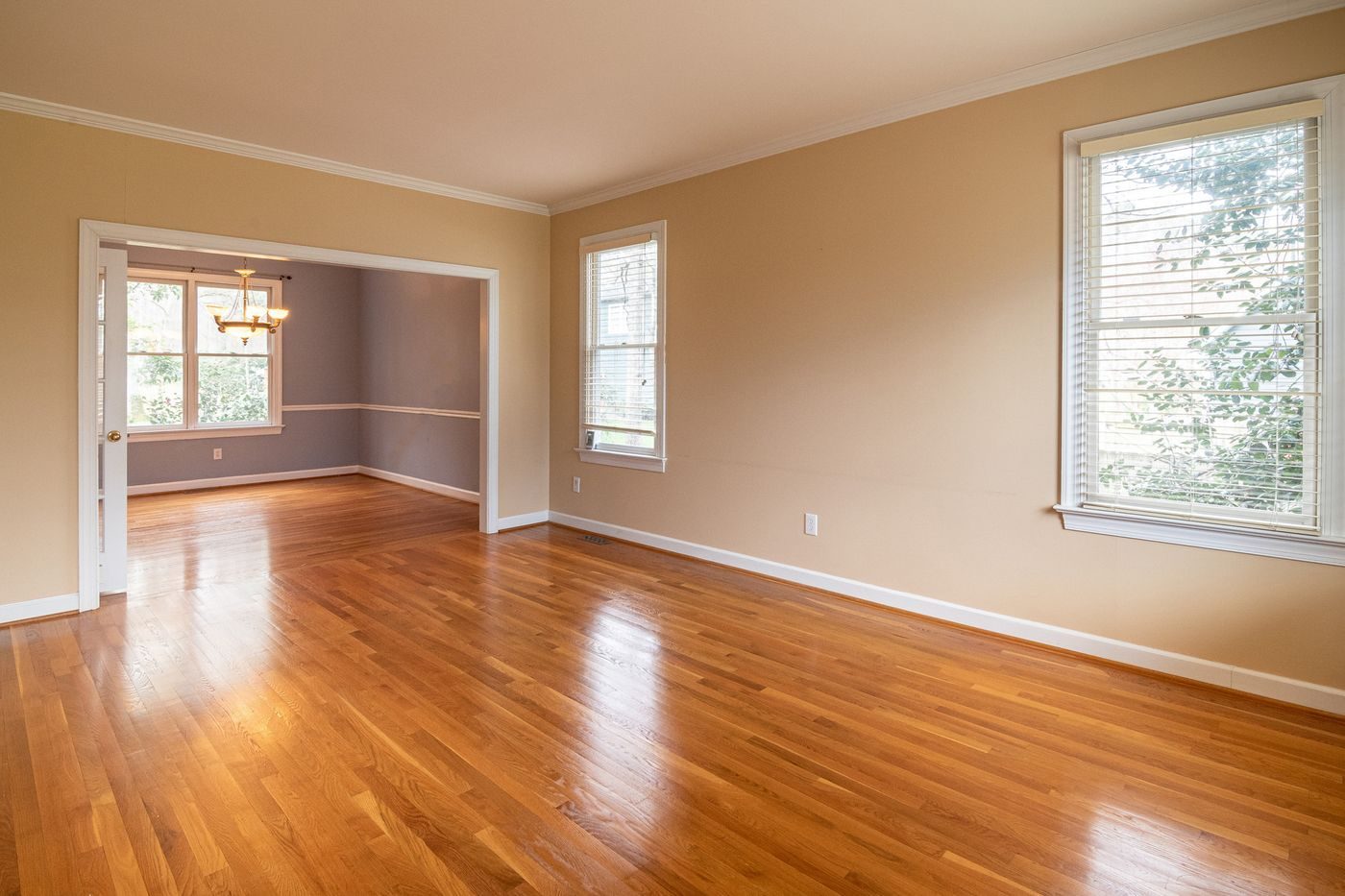 Dated room with worn, orange-toned floors before renovation