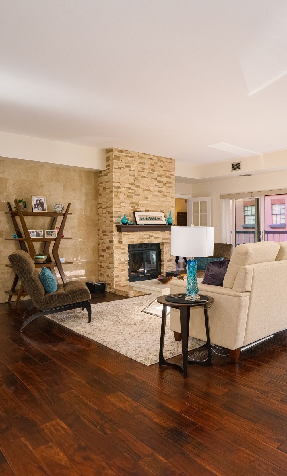 Warm wood-look vinyl plank flooring in a living room with fireplace